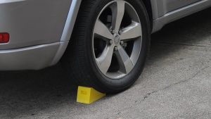 Wheel chock. Vehicle wheel chock used on family car to prevent accidents